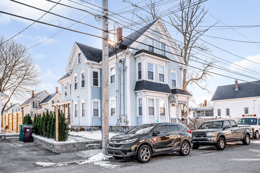 339 Lincoln Street, Unit 2 Lowell, MA 01852 - Photo 15 of 18 a view of a cars park in front of a building