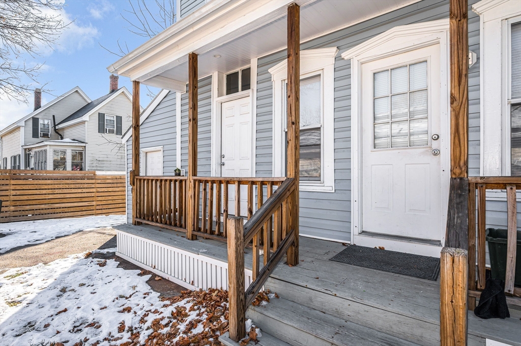 339 Lincoln Street, Unit 2 Lowell, MA 01852 - Photo 16 of 18 a view of a house with wooden floor roof and wooden fence