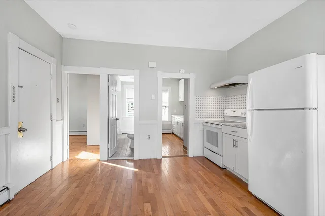 a kitchen with stainless steel appliances a refrigerator and a stove top oven