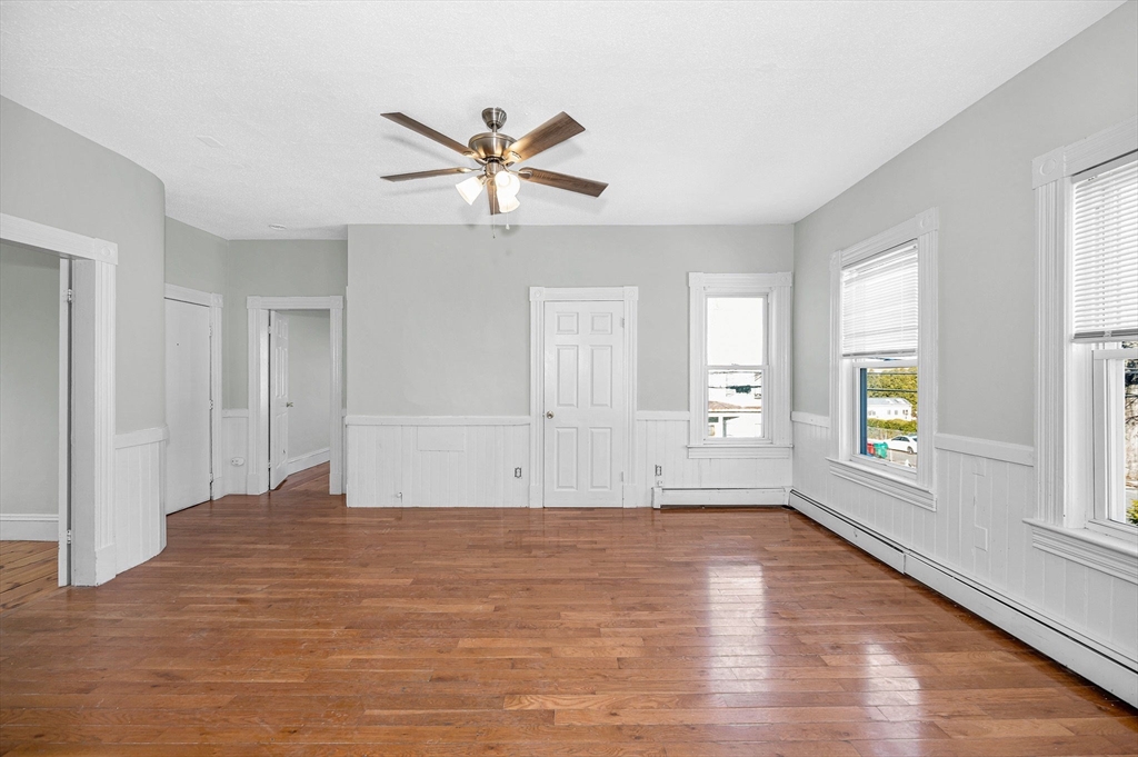 339 Lincoln Street, Unit 2 Lowell, MA 01852 - Photo 5 of 18 a view of empty room with wooden floor and window