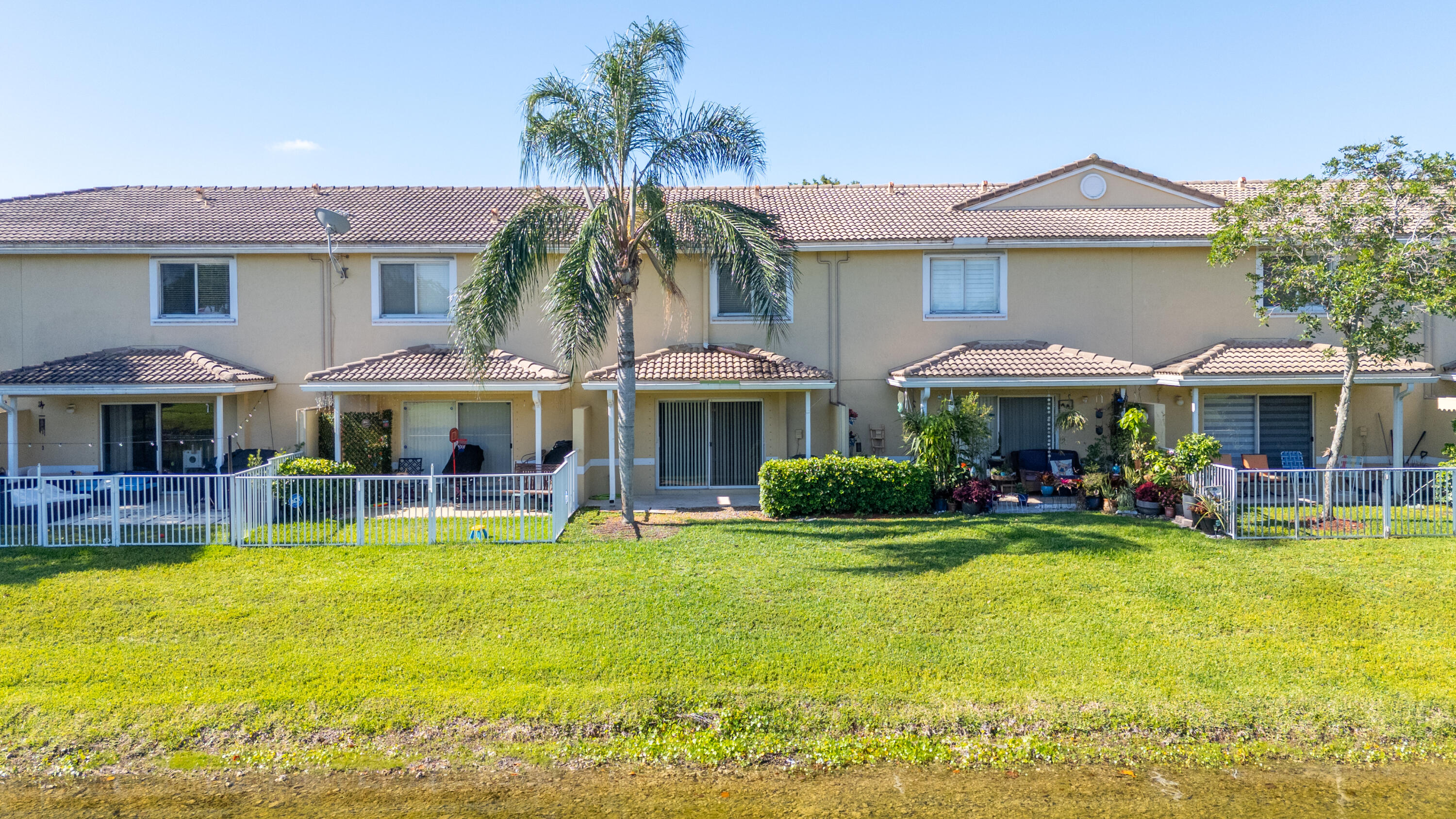 9107 Chambers Street, Unit 9107 Tamarac, FL 33321 - Photo 13 of 30 a view of a swimming pool with lawn chairs under an umbrella