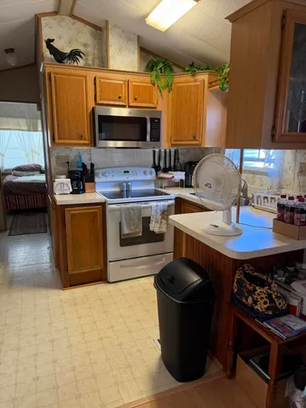 a kitchen with a sink appliances and cabinets