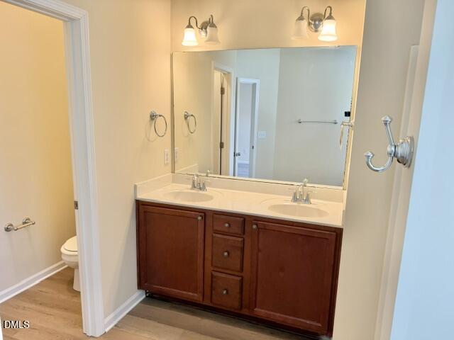 8227 Primanti Boulevard Raleigh, NC 27612 - Photo 16 of 25 a bathroom with a double vanity sink and a mirror