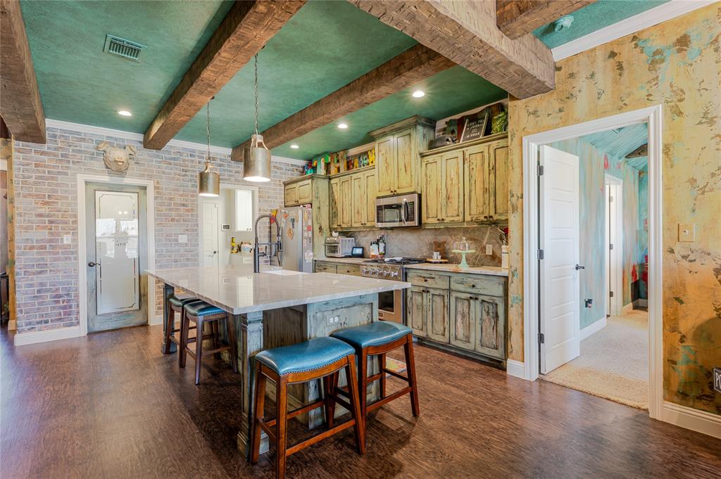 470 Wilson Bend Road Millsap, TX 76066 - Photo 12 of 39 a kitchen with table chairs cabinets and wooden floor
