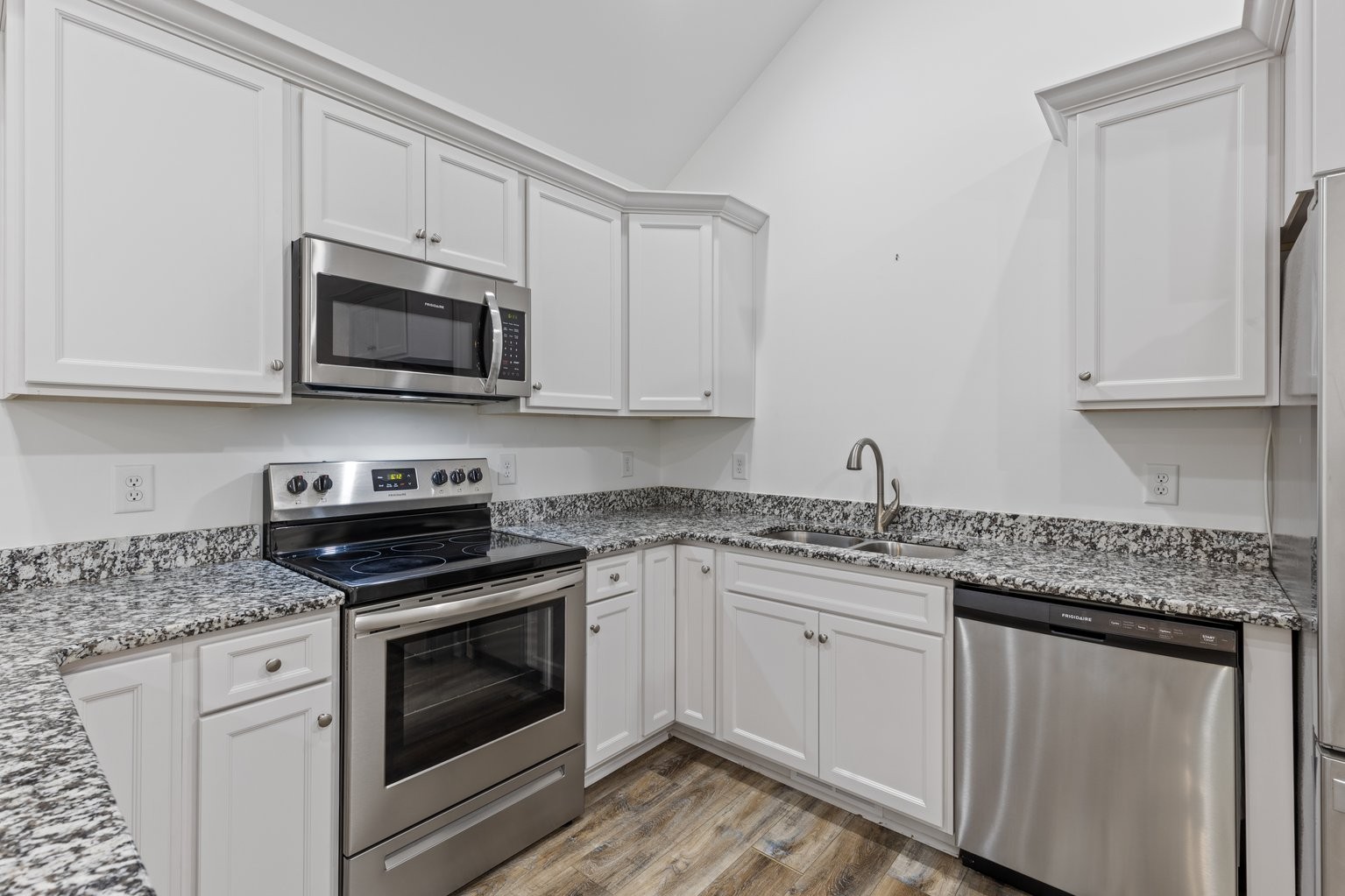 10580 Church Road Bon Aqua, TN 37025 - Photo 11 of 29 a kitchen with granite countertop white cabinets sink and stainless steel appliances