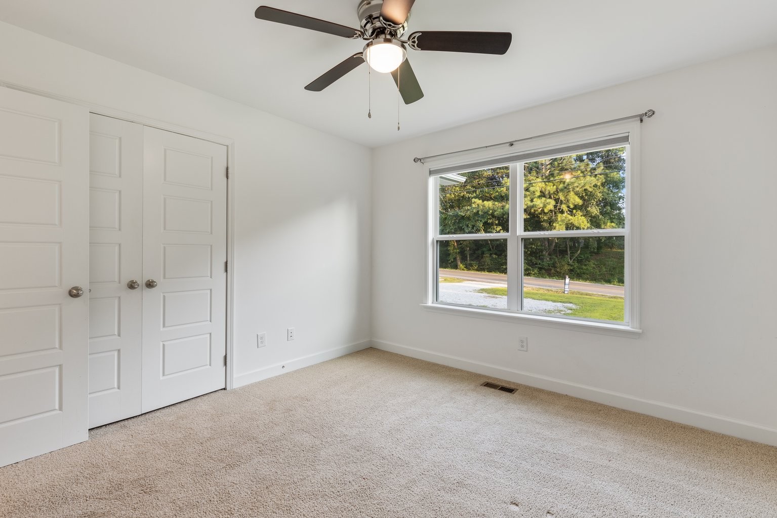 10580 Church Road Bon Aqua, TN 37025 - Photo 19 of 29 an empty room with a window and a ceiling fan