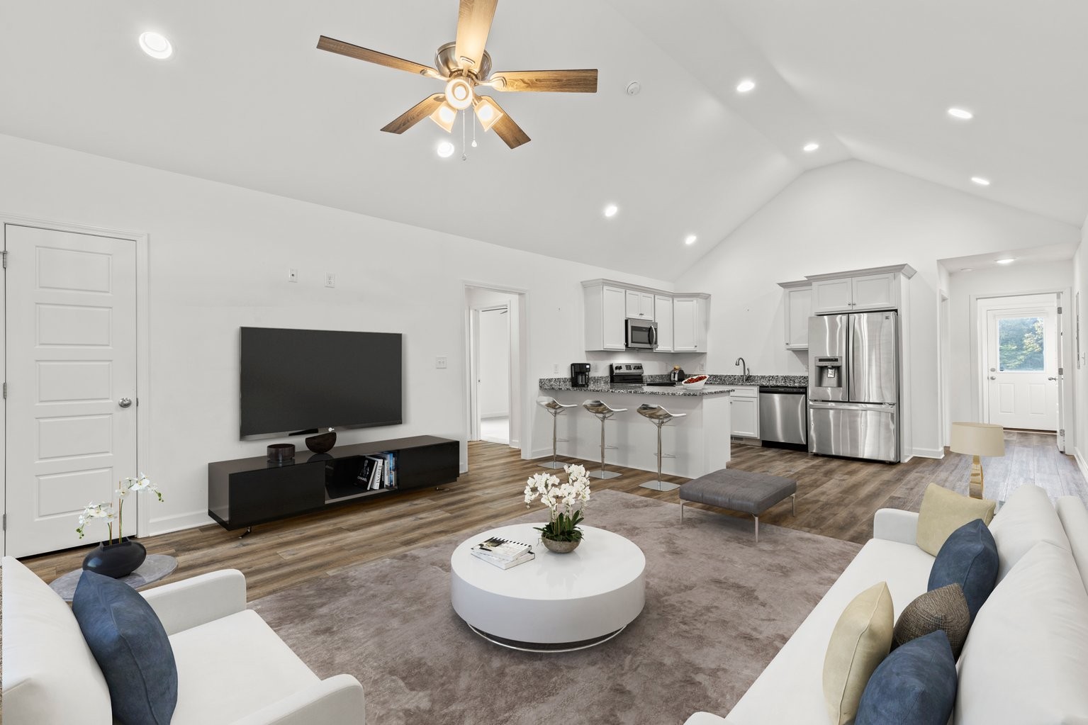 10580 Church Road Bon Aqua, TN 37025 - Photo 2 of 29 a living room with furniture a flat screen tv and kitchen view