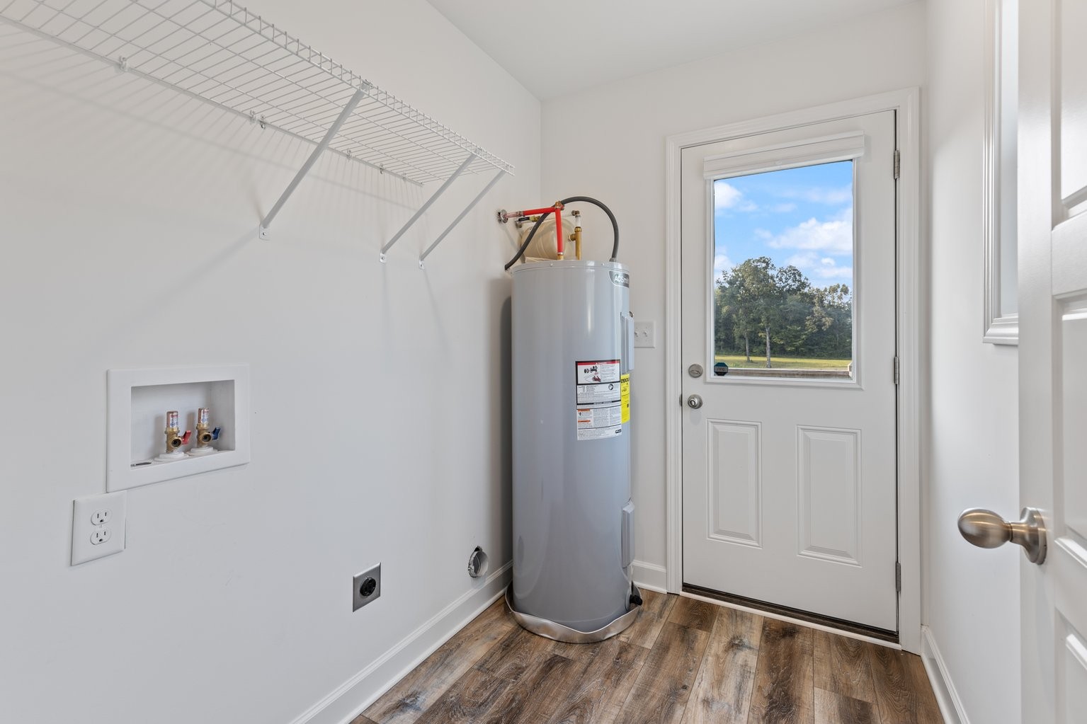 10580 Church Road Bon Aqua, TN 37025 - Photo 23 of 29 a view of a hallway with wooden floor and entryway