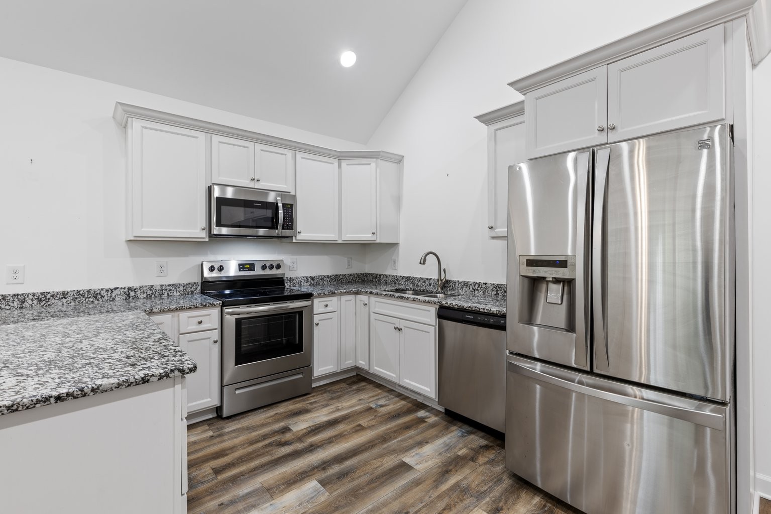 10580 Church Road Bon Aqua, TN 37025 - Photo 8 of 29 a kitchen with granite countertop a refrigerator stove and microwave