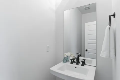 a kitchen with stainless steel appliances granite countertop a stove a sink a dining table with chairs and wooden floor