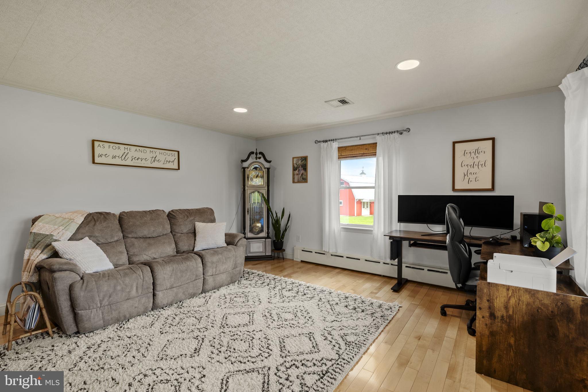 218 Lauschtown Road Denver, PA 17517 - Photo 23 of 78 a living room with furniture and a flat screen tv