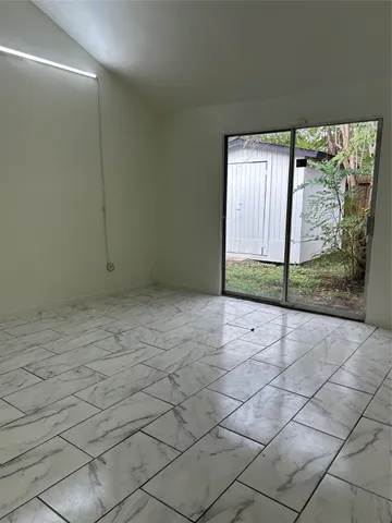 a view of an empty room with a window