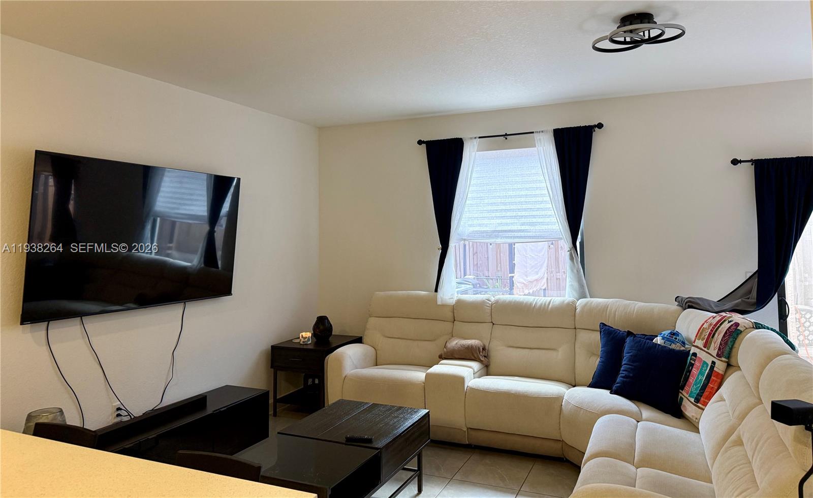 23049 Southwest 129th Place Miami, FL 33177 - Photo 5 of 29 a living room with furniture and a flat screen tv