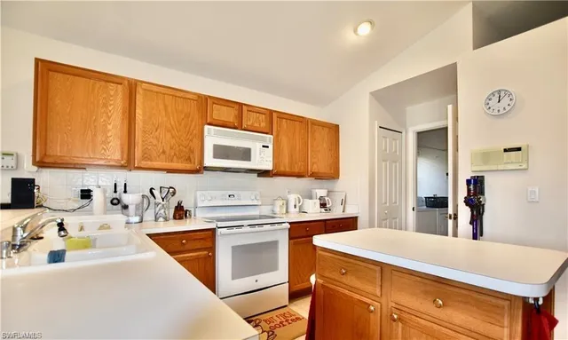 a kitchen with a sink stove and cabinets