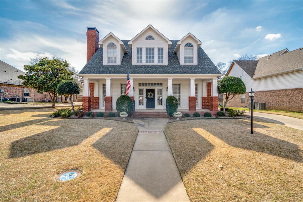 8 Griffith Court Terrell, TX 75160 - Photo 1 of 25 New england style home with a front yard, a porch, brick siding, roof with shingles, and a chimney