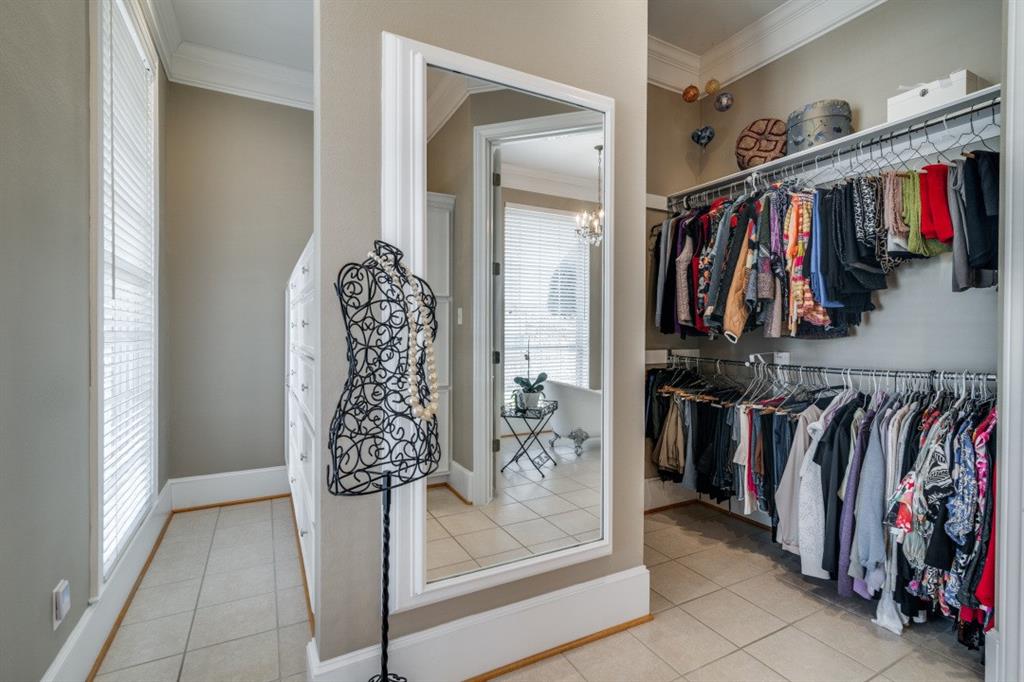 8 Griffith Court Terrell, TX 75160 - Photo 17 of 25 Walk in closet with light tile flooring and a chandelier