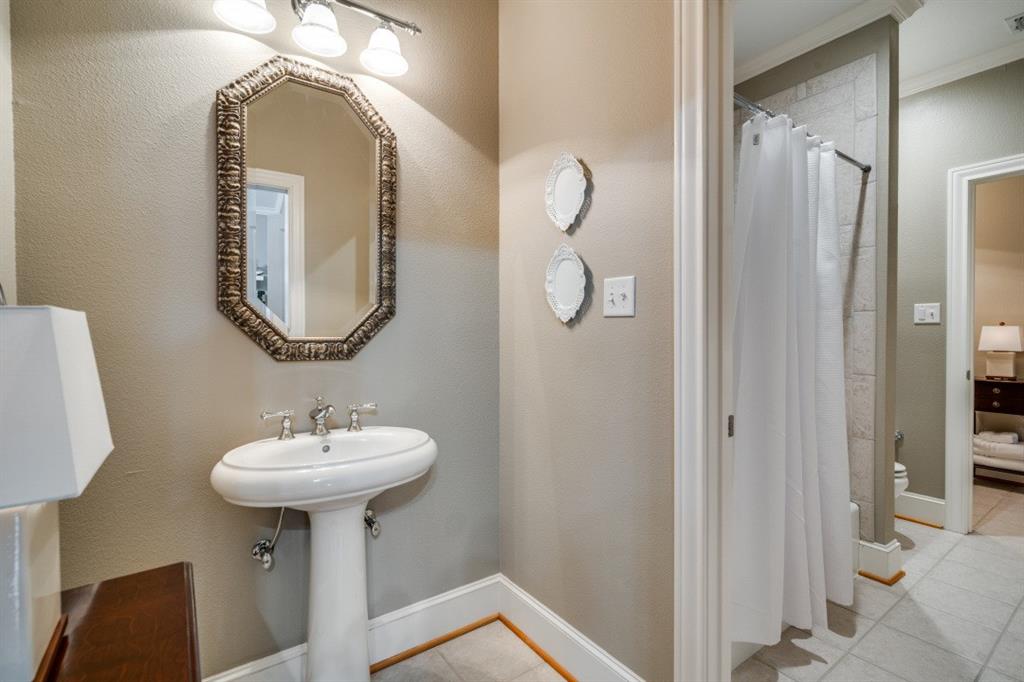 8 Griffith Court Terrell, TX 75160 - Photo 20 of 25 Full Jack and Jill bathroom with curtained shower, double vanities, and light tile floors