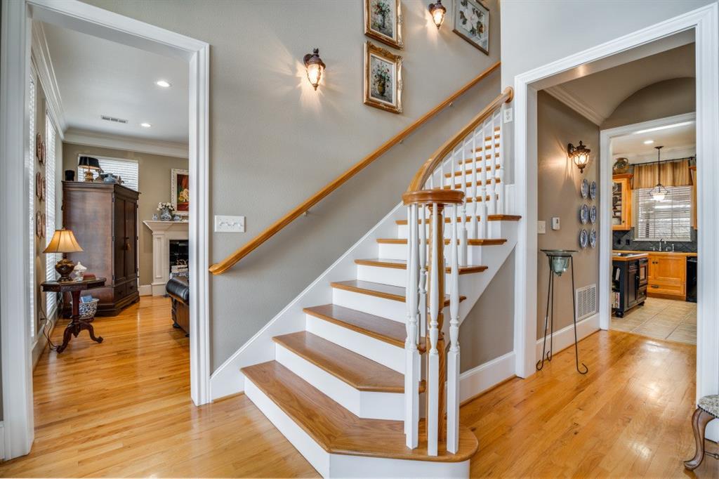 8 Griffith Court Terrell, TX 75160 - Photo 4 of 25 Staircase with ornamental molding and hardwood finished floors