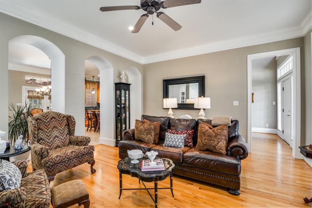 8 Griffith Court Terrell, TX 75160 - Photo 6 of 25 Living area with ceiling fan, light hardwood floors, crown molding, and arched walkways