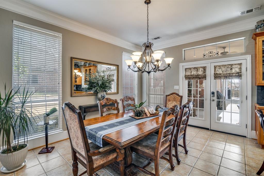 8 Griffith Court Terrell, TX 75160 - Photo 7 of 25 Dining area featuring french doors leading to patio, light tile floors, crown molding, and hanging lights