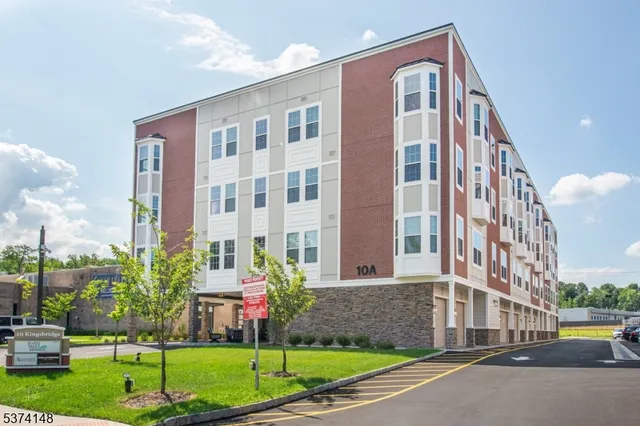 a front view of a building with a yard
