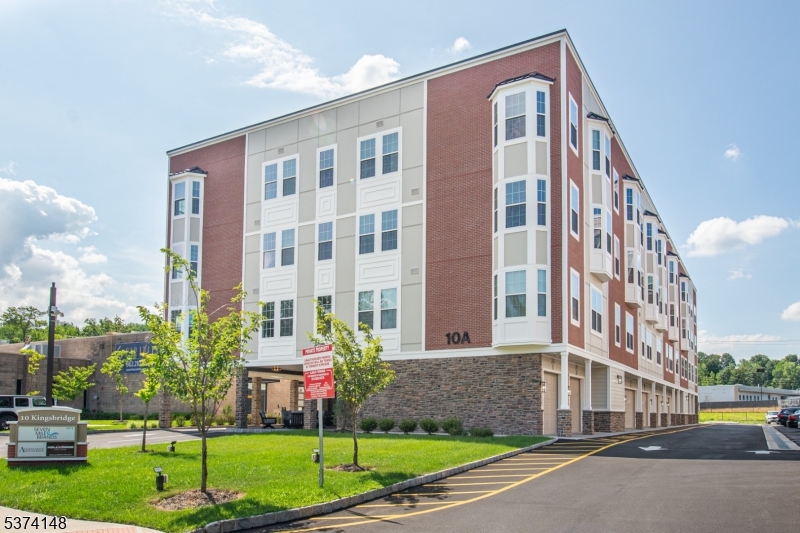 10 Kingsbridge Road, Unit 207 Fairfield, NJ 07004 - Photo 1 of 15 a front view of a building with a yard