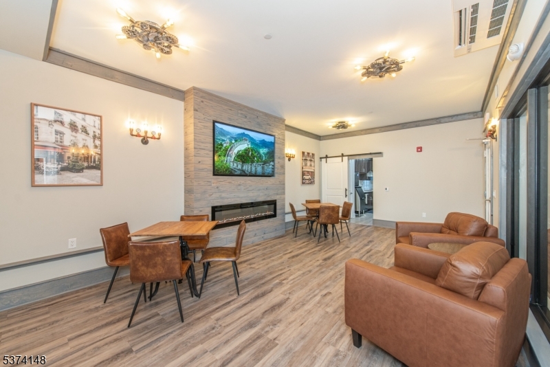 10 Kingsbridge Road, Unit 207 Fairfield, NJ 07004 - Photo 11 of 15 a living room with furniture and a flat screen tv