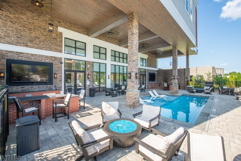 10 Kingsbridge Road, Unit 207 Fairfield, NJ 07004 - Photo 15 of 15 a outdoor space with patio the couches and a dining table with the garden view