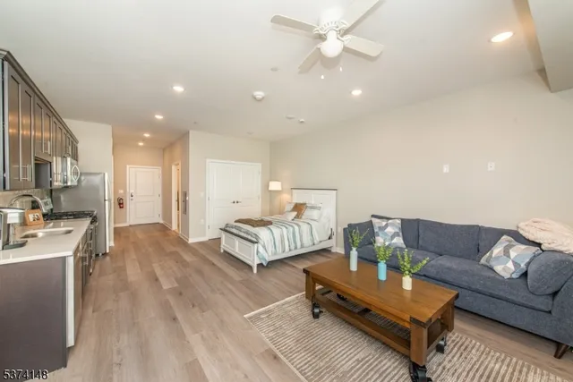 a living room with furniture and a chandelier