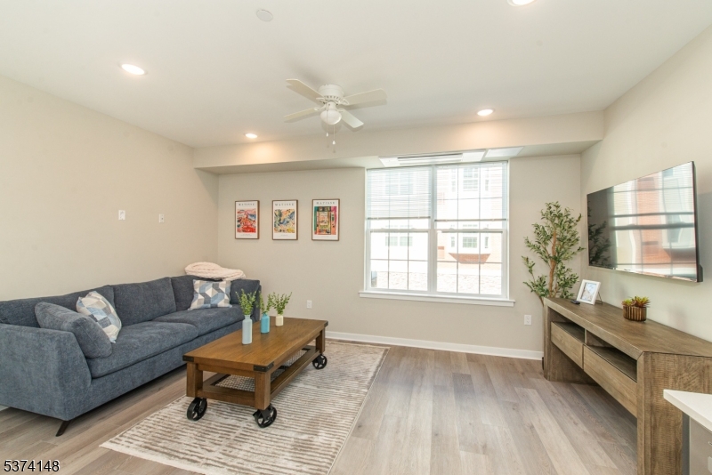 10 Kingsbridge Road, Unit 207 Fairfield, NJ 07004 - Photo 6 of 15 a living room with furniture and a window