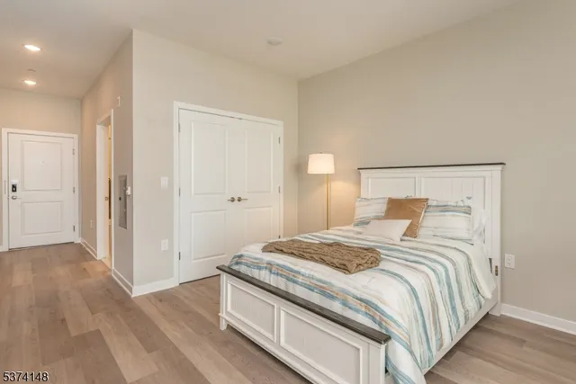 a bedroom with a bed and wooden floor