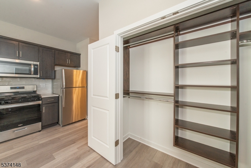 10 Kingsbridge Road, Unit 207 Fairfield, NJ 07004 - Photo 9 of 15 a view of a kitchen with a refrigerator an oven