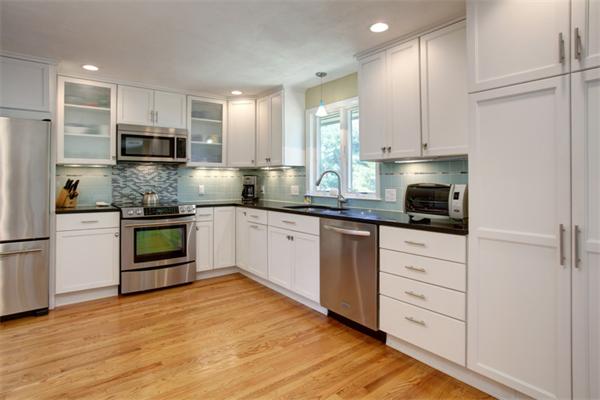 15 Goffe Road Lexington, MA 02421 - Photo 3 of 10 a kitchen with granite countertop white cabinets and stainless steel appliances