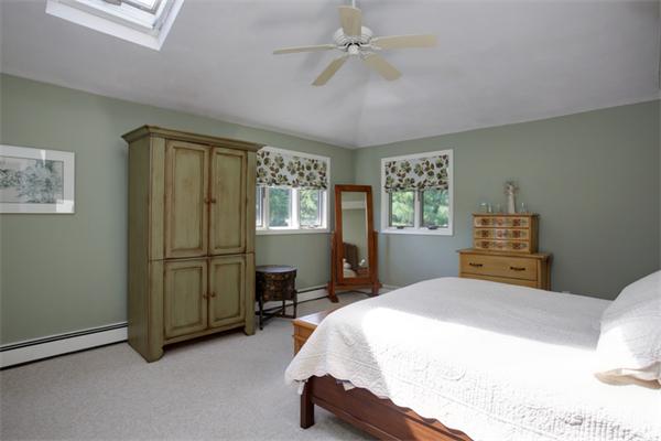 15 Goffe Road Lexington, MA 02421 - Photo 7 of 10 a bedroom with a bed and a chandelier