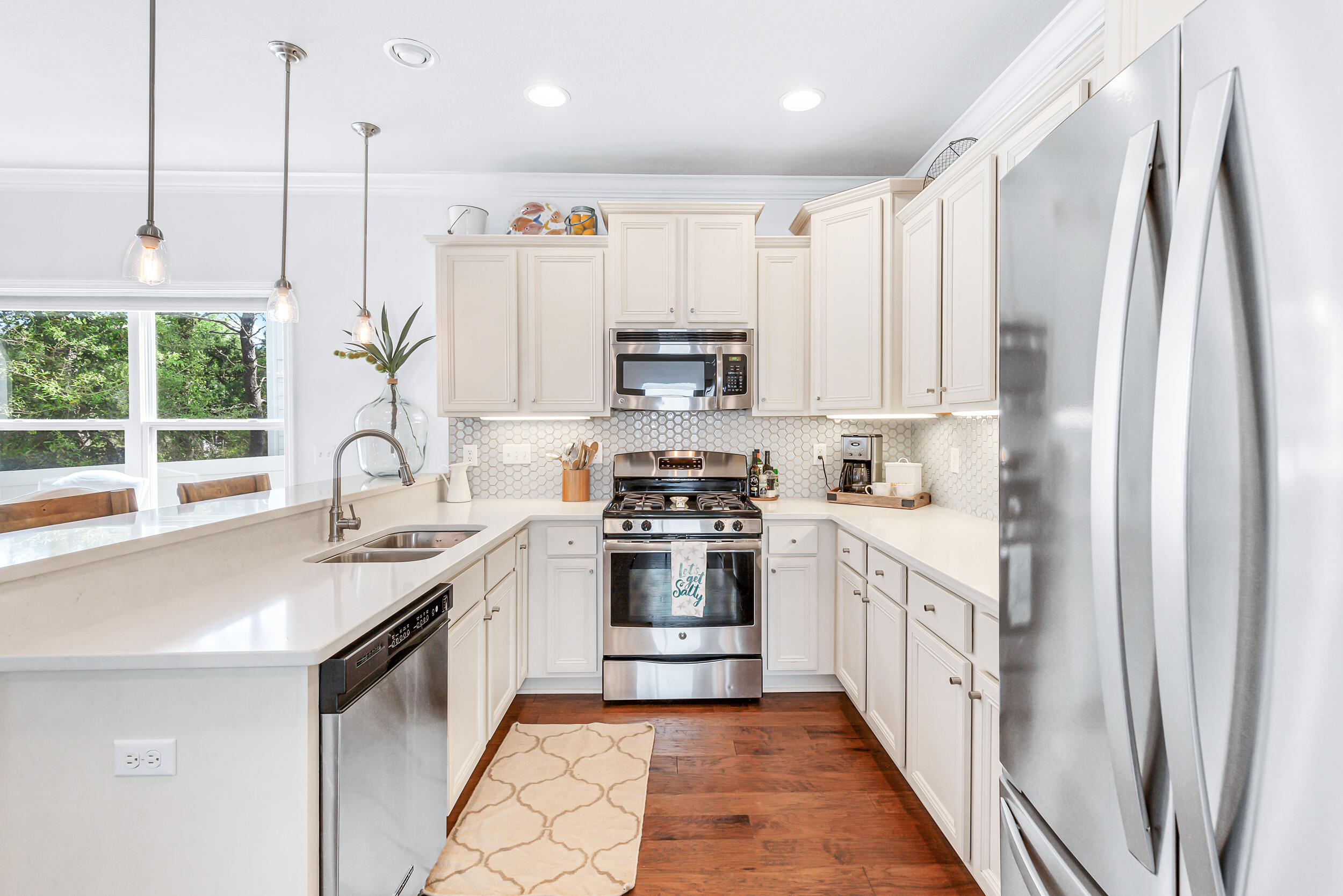 136 Grayling Way Inlet Beach, FL 32461 - Photo 7 of 22 a kitchen with stainless steel appliances granite countertop a stove a sink and a refrigerator