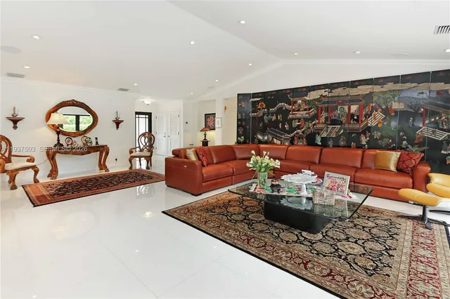 a living room with furniture a rug and a wall painting