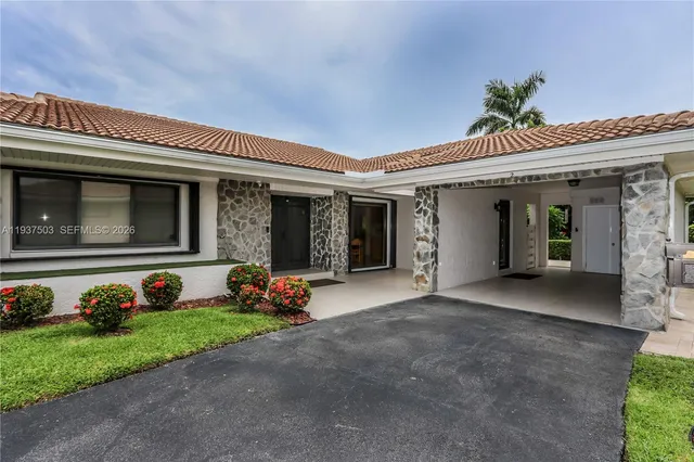 a front view of a house with garden