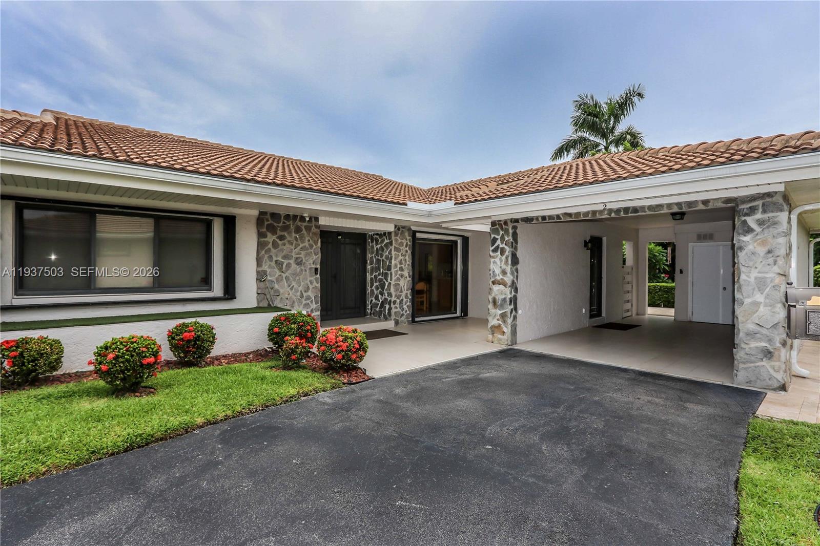 3650 North 36th Avenue, Unit 2 Hollywood, FL 33021 - Photo 2 of 52 a front view of a house with garden