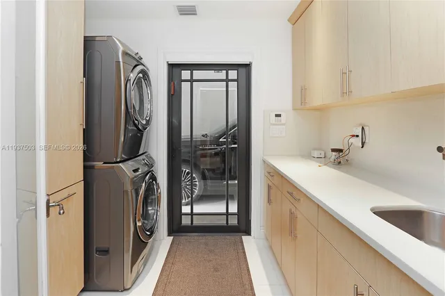 a kitchen with a refrigerator sink and cabinets