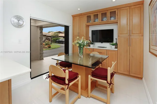 a dining room with furniture a fireplace and wooden floor