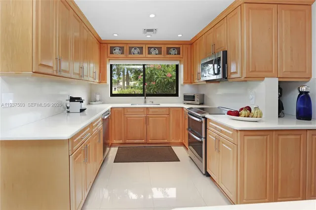 a kitchen that has a sink and a stove in it