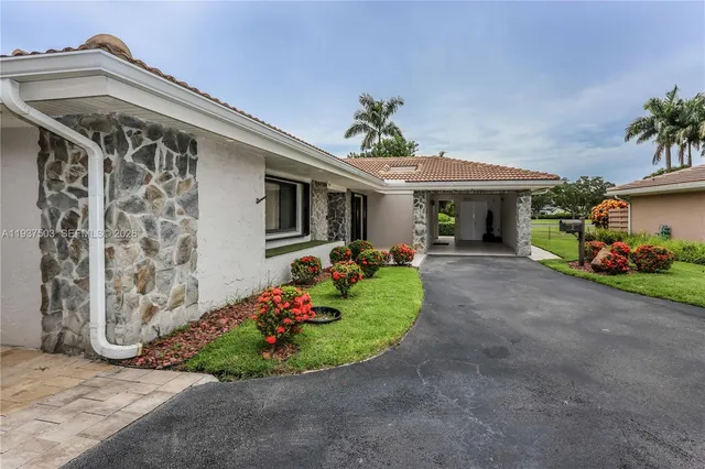 a front view of a house with garden