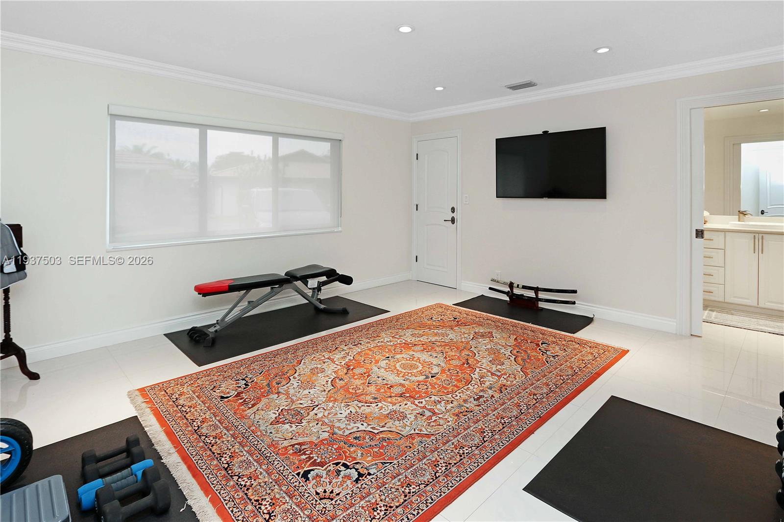 3650 North 36th Avenue, Unit 2 Hollywood, FL 33021 - Photo 31 of 52 a living room with a flat screen tv and a couch