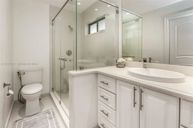 a spacious bedroom with a bed a lamp and a large window