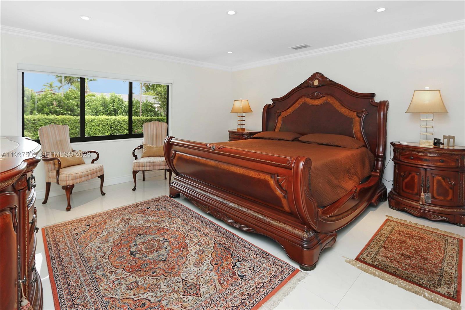 3650 North 36th Avenue, Unit 2 Hollywood, FL 33021 - Photo 34 of 52 a spacious bedroom with a bed a lamp and a large window