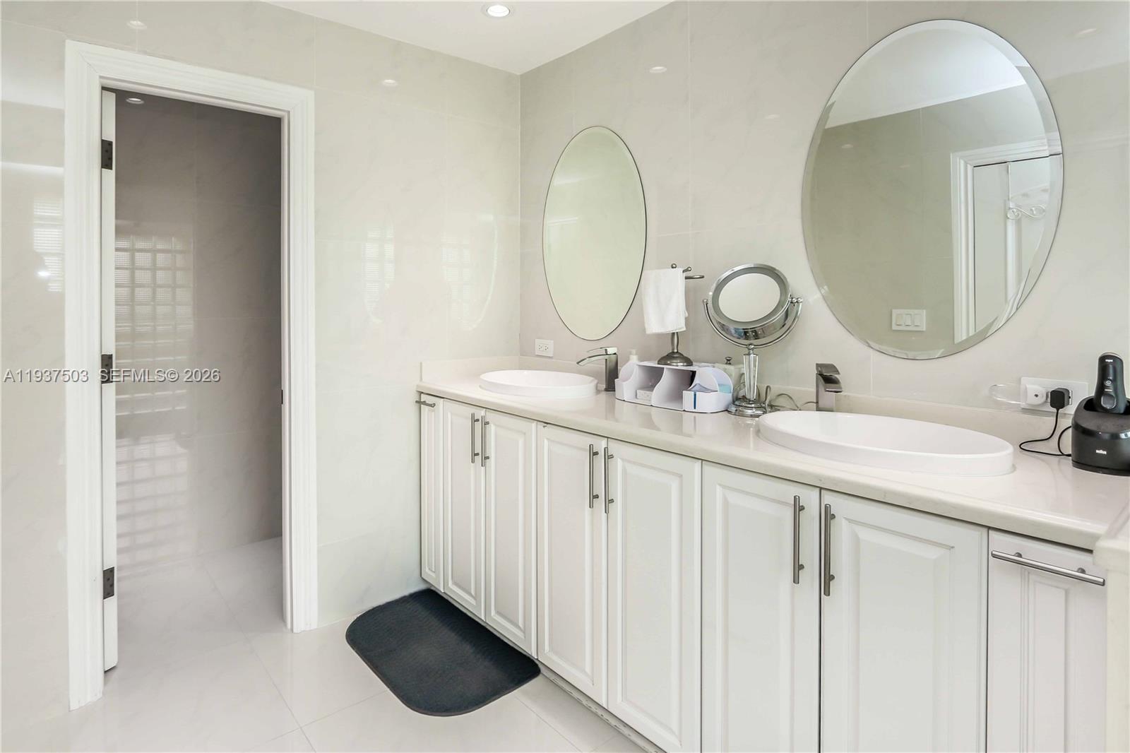 3650 North 36th Avenue, Unit 2 Hollywood, FL 33021 - Photo 36 of 52 a bathroom with a double vanity sink and a mirror