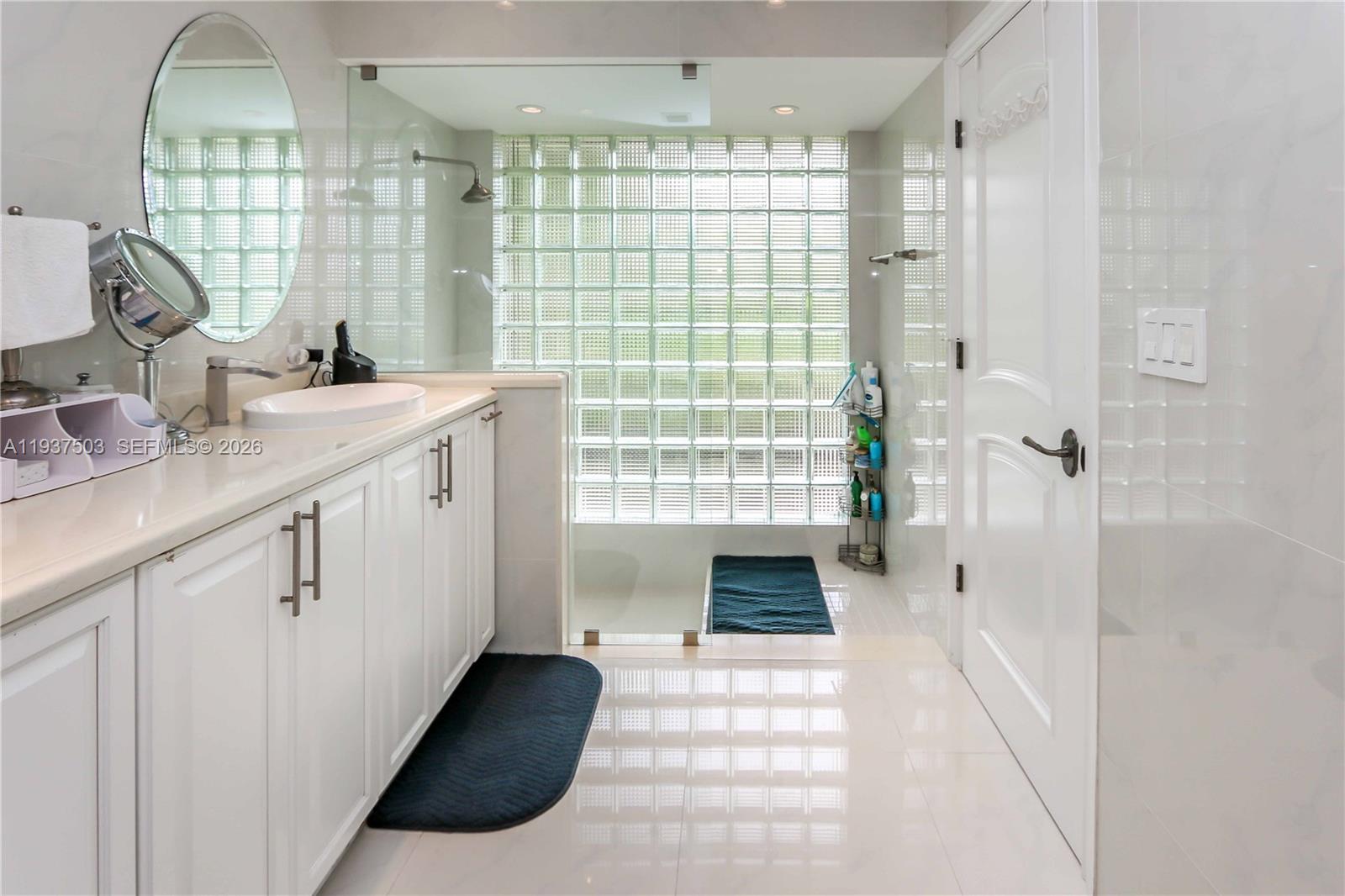 3650 North 36th Avenue, Unit 2 Hollywood, FL 33021 - Photo 37 of 52 a bathroom with a double vanity sink and mirror