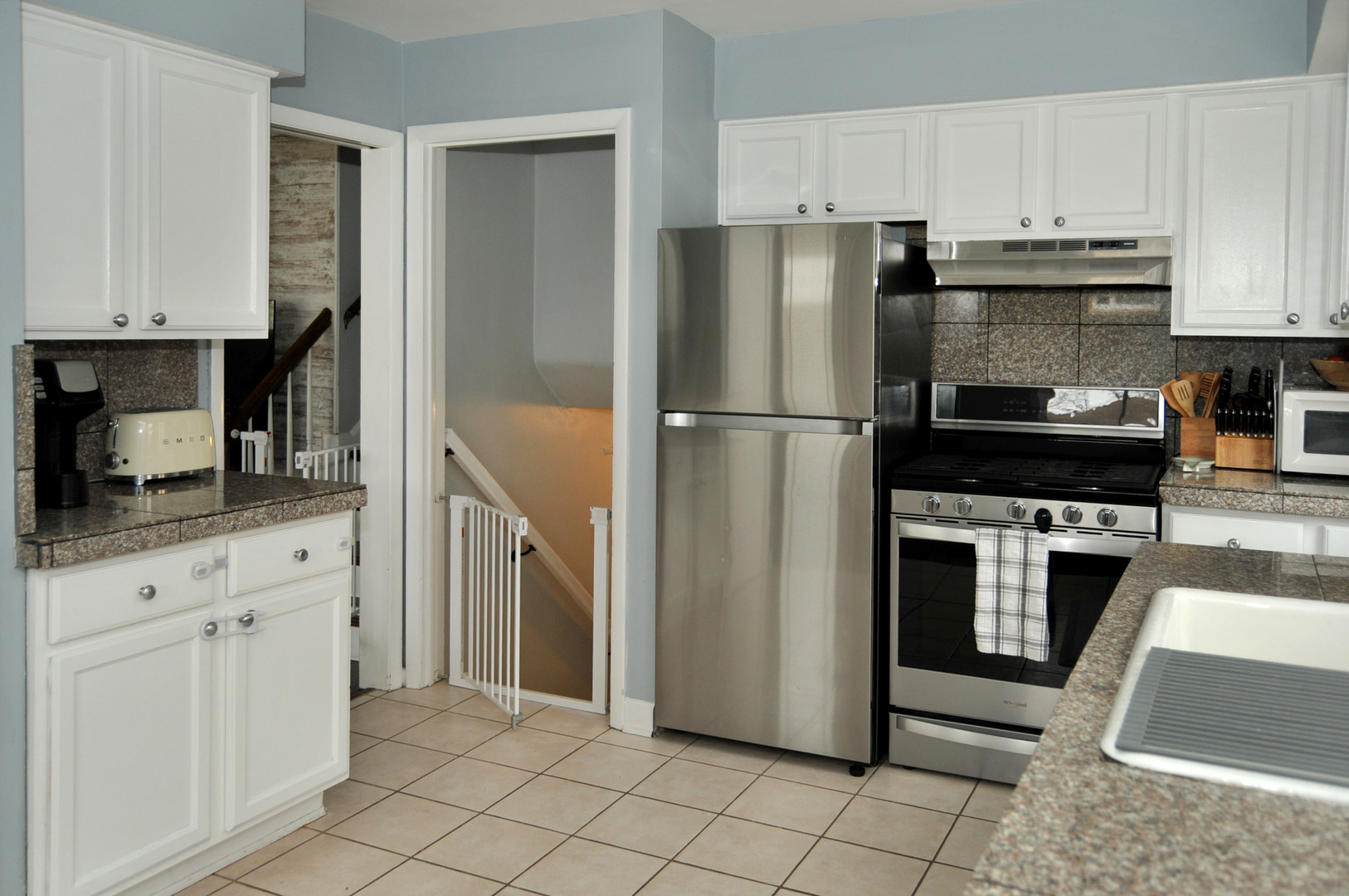 4417 Arthur Avenue Brookfield, IL 60513 - Photo 4 of 19 a kitchen with cabinets and stainless steel appliances