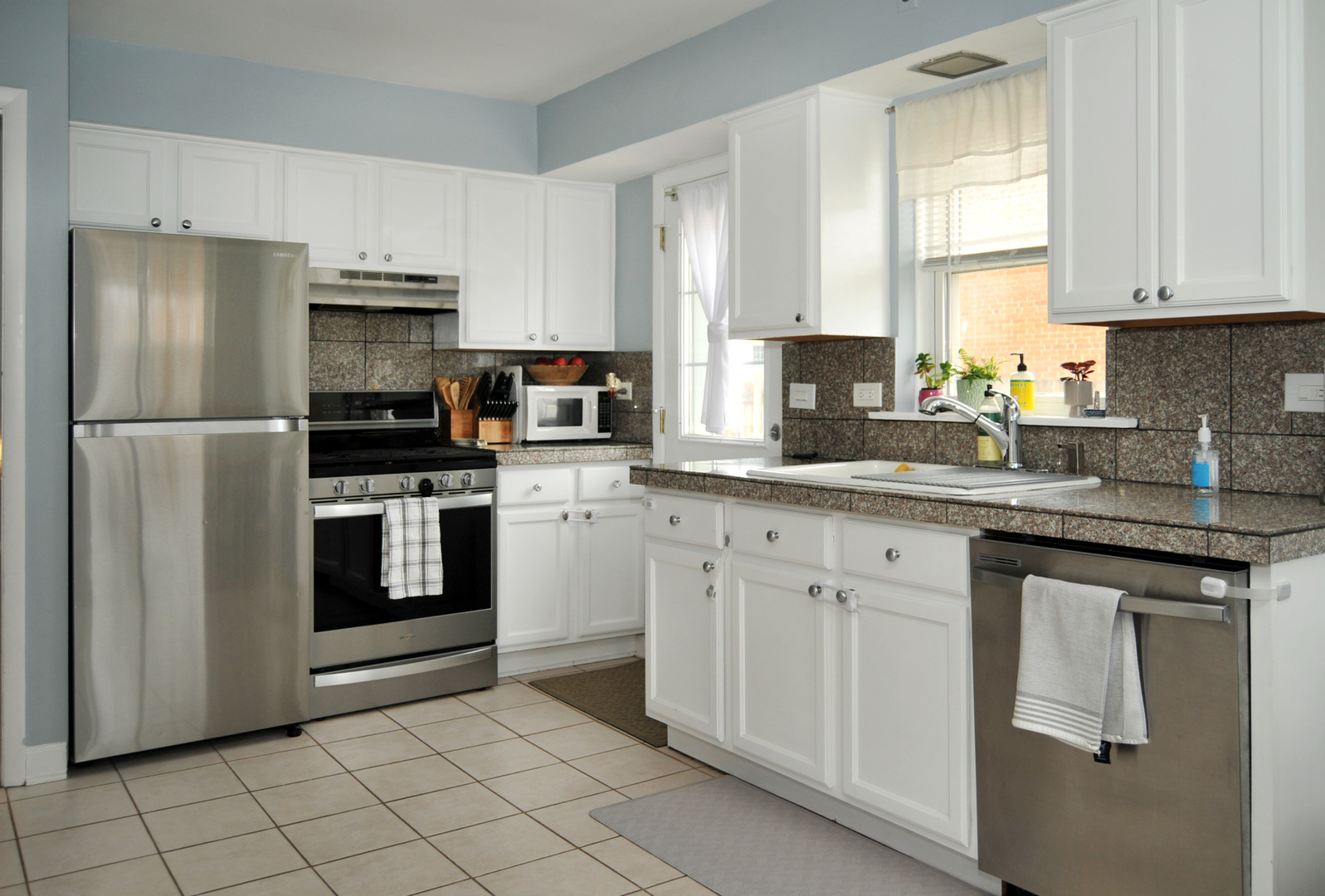 4417 Arthur Avenue Brookfield, IL 60513 - Photo 5 of 19 a kitchen with white cabinets white stainless steel appliances and sink