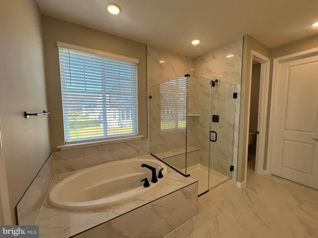 a spacious bathroom with double vanity and mirrors